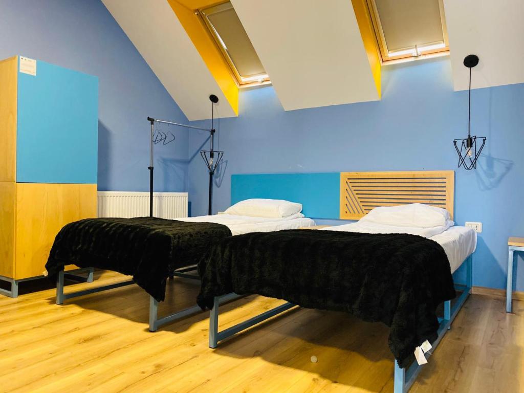 Attic twin with yellow skylights and oak floor